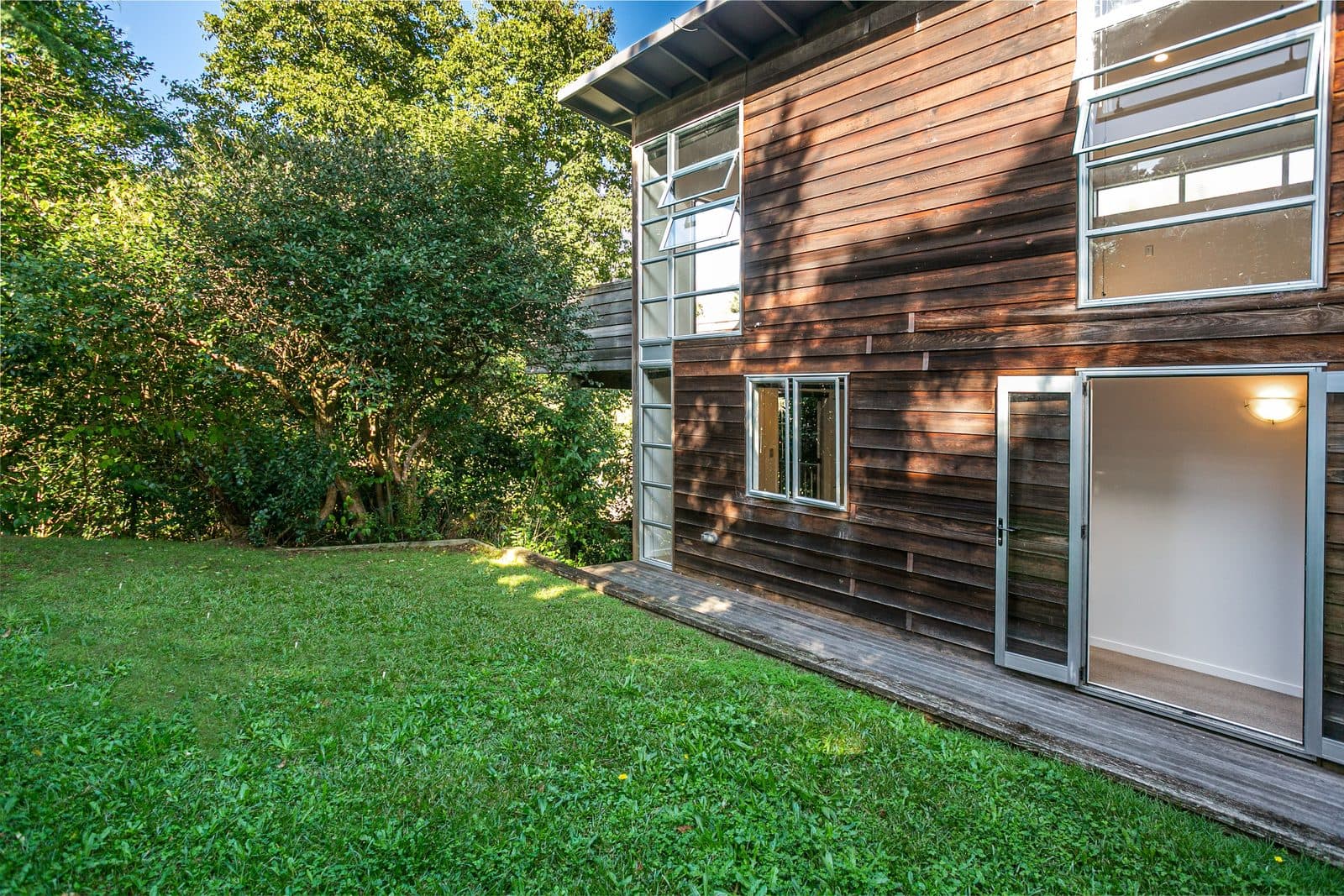 A two-storey cedar-clad home set in a leafy garden in Avondale