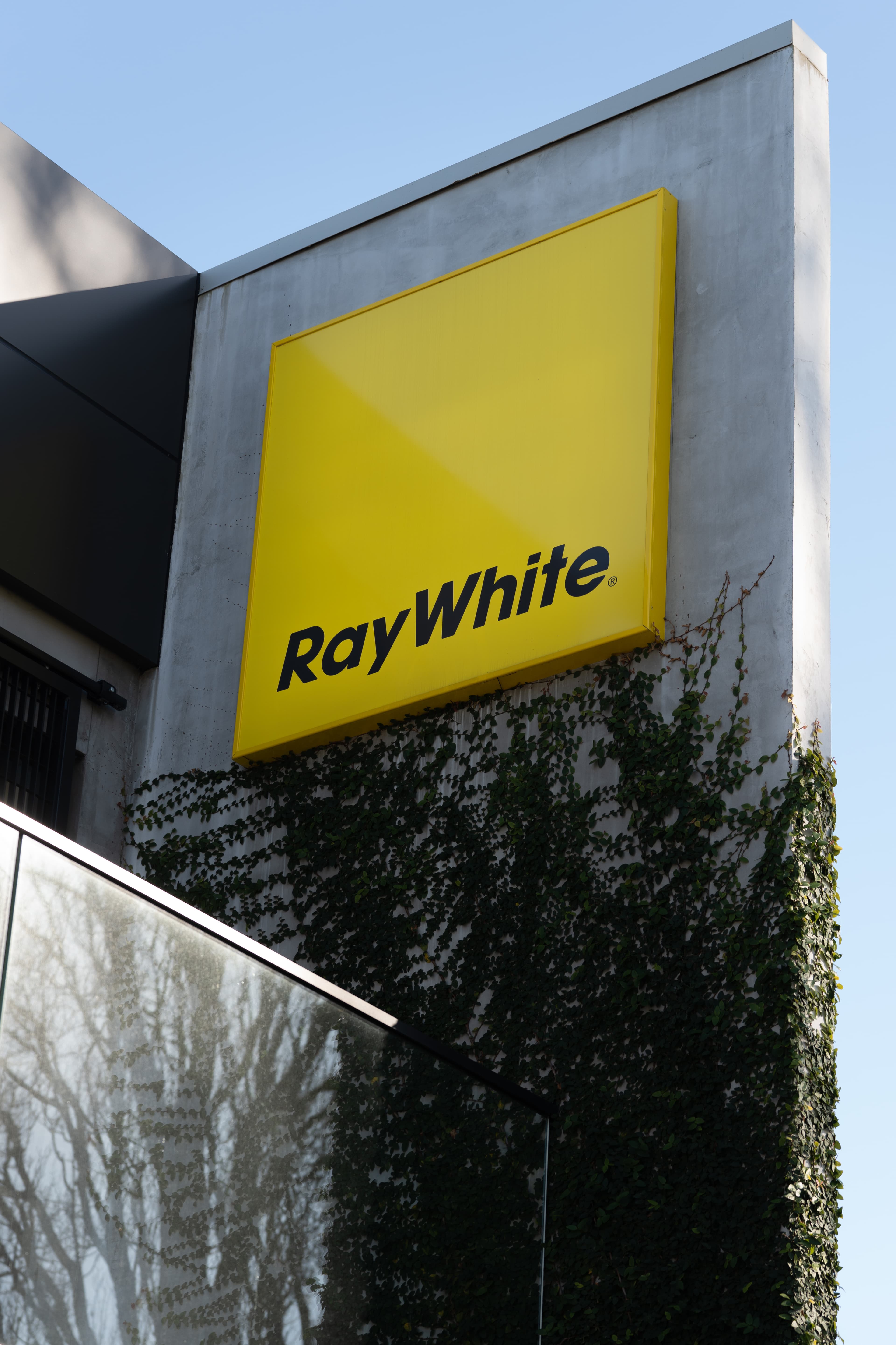 Ray White signage on the exterior of an A T Realty office