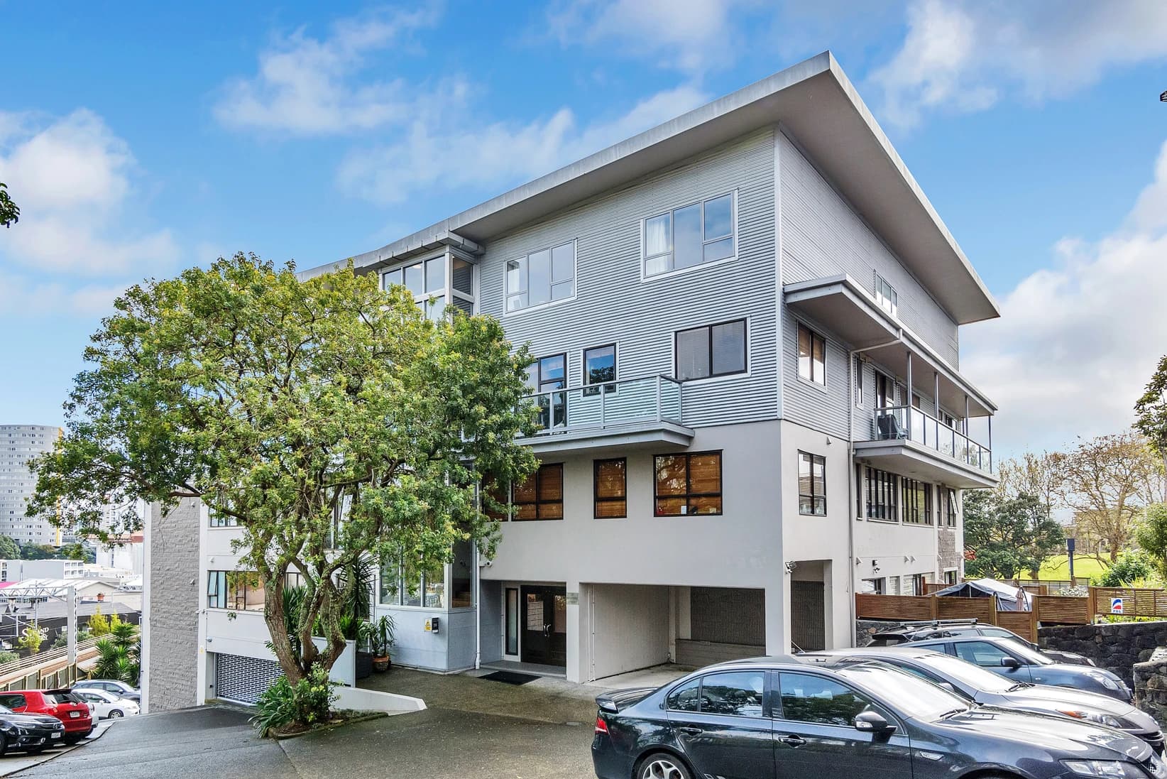 Modern Parnell apartment building with landscaped entrance and harbour views